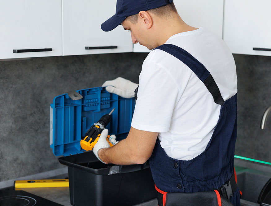 Plumber selecting tools from a toolbox